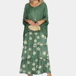 Dark green tiered maxi dress with white daisy print on the skirt layers