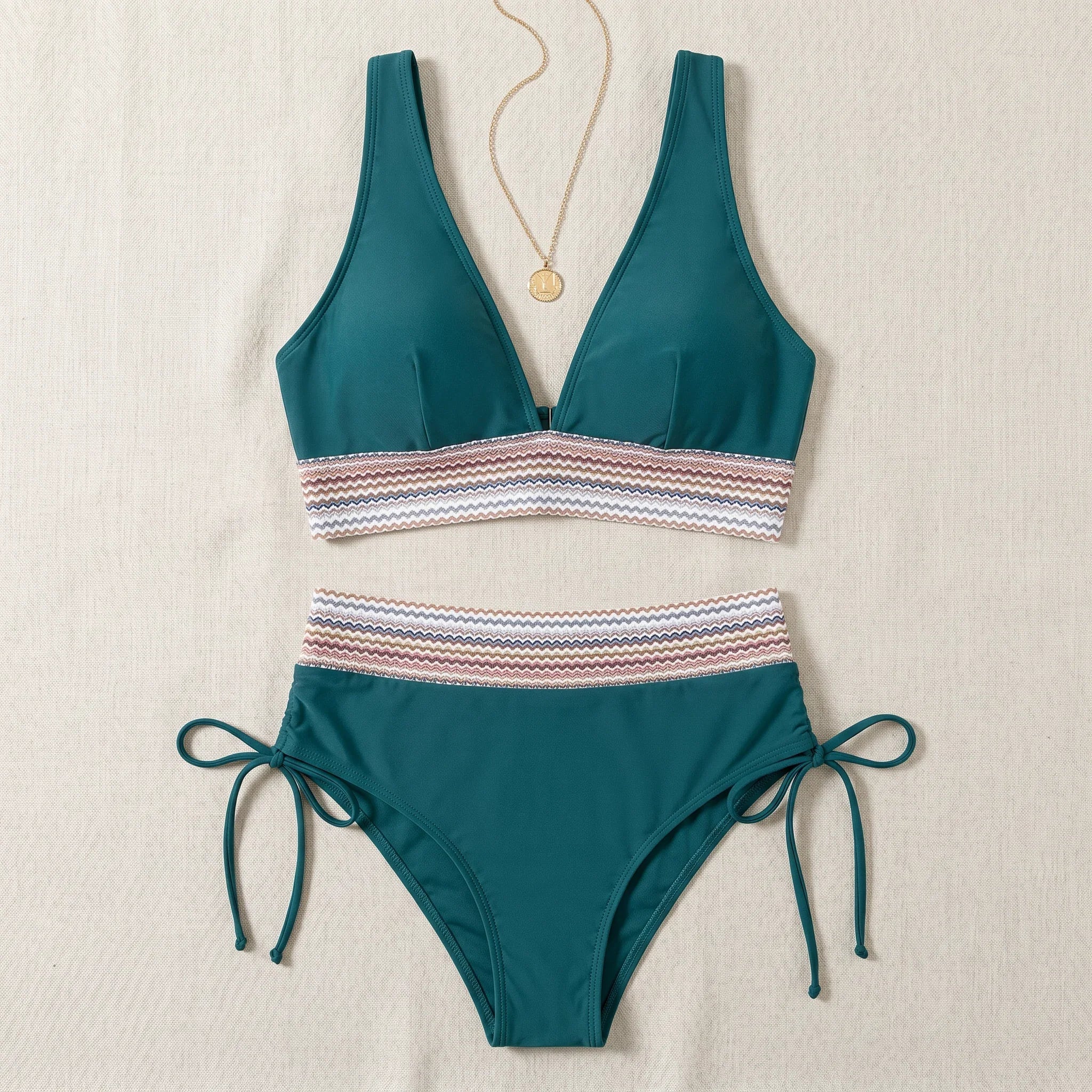Teal two-piece swimsuit set: V-neck triangle top and high-waist tie-side bottoms with striped band.