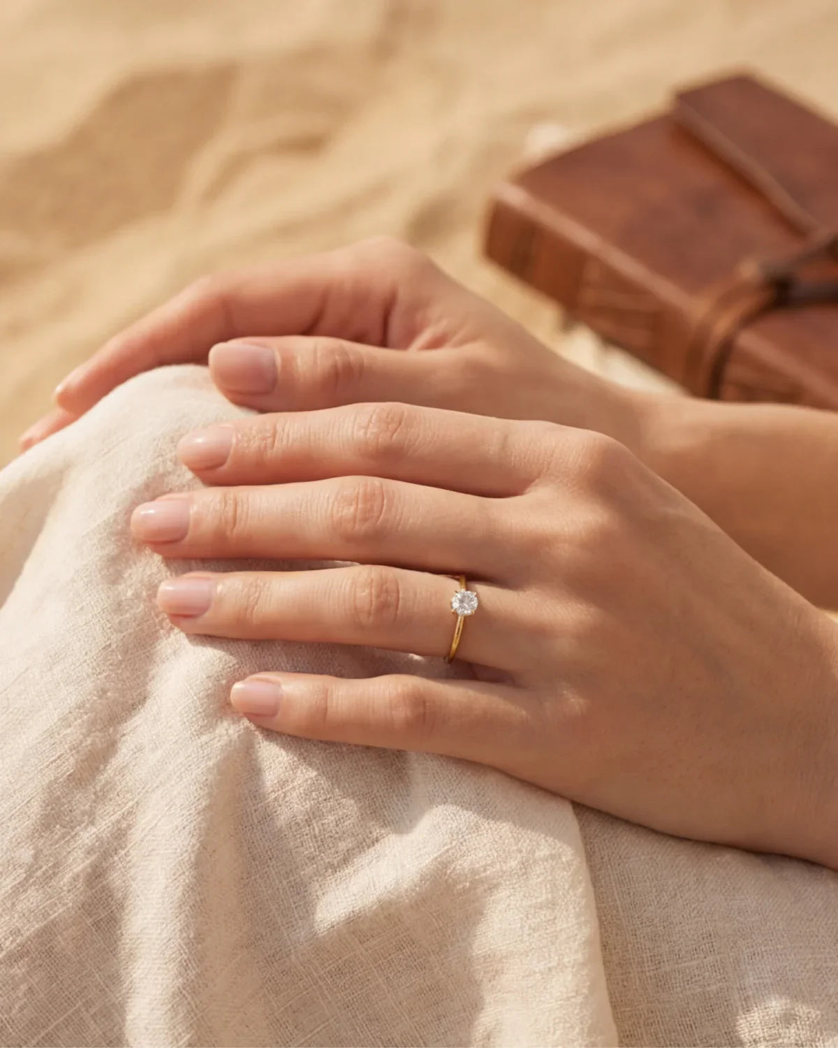 Small solitaire ring with round gemstone on finger