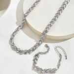 Silver fish tail link necklace set with matching bracelet pieces on display