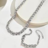 Silver fish tail link necklace set with matching bracelet pieces on display