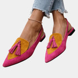 Pink suede heeled sandals with yellow panel, tassel fringe, and black heel