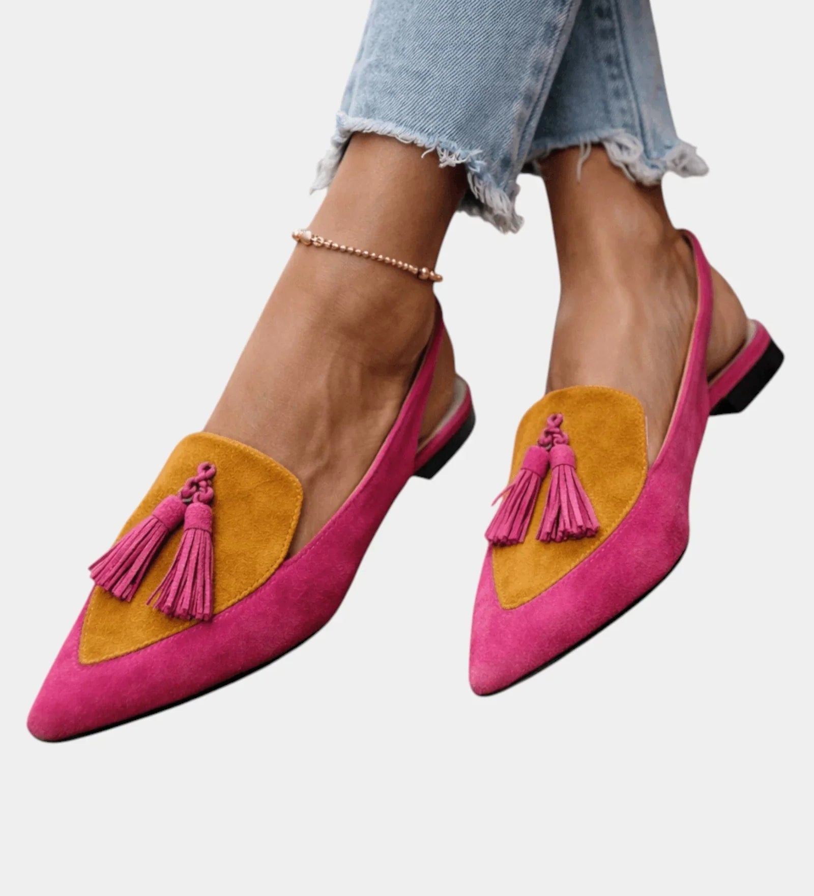 Pink suede heeled sandals with yellow panel, tassel fringe, and black heel