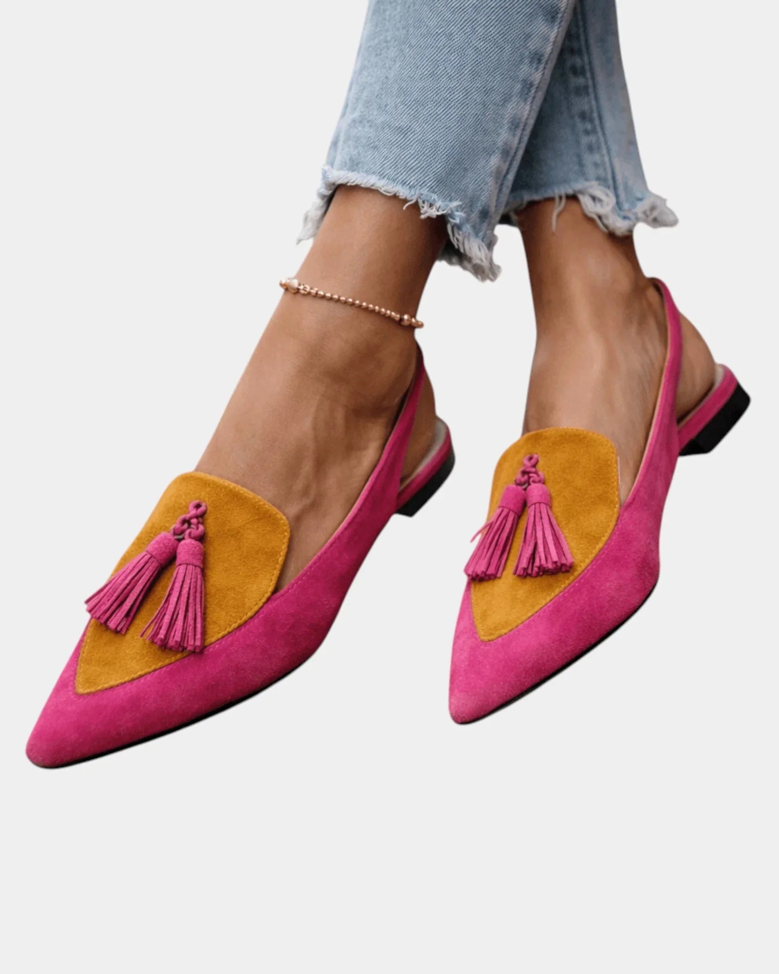 Pink suede heeled sandals with yellow panel, tassel fringe, and black heel