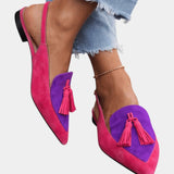 Pink suede heeled sandals with purple panel, tassel fringe, and black heel