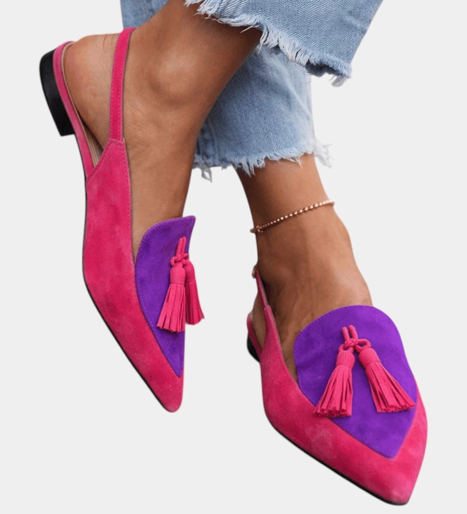 Pink suede heeled sandals with purple panel, tassel fringe, and black heel