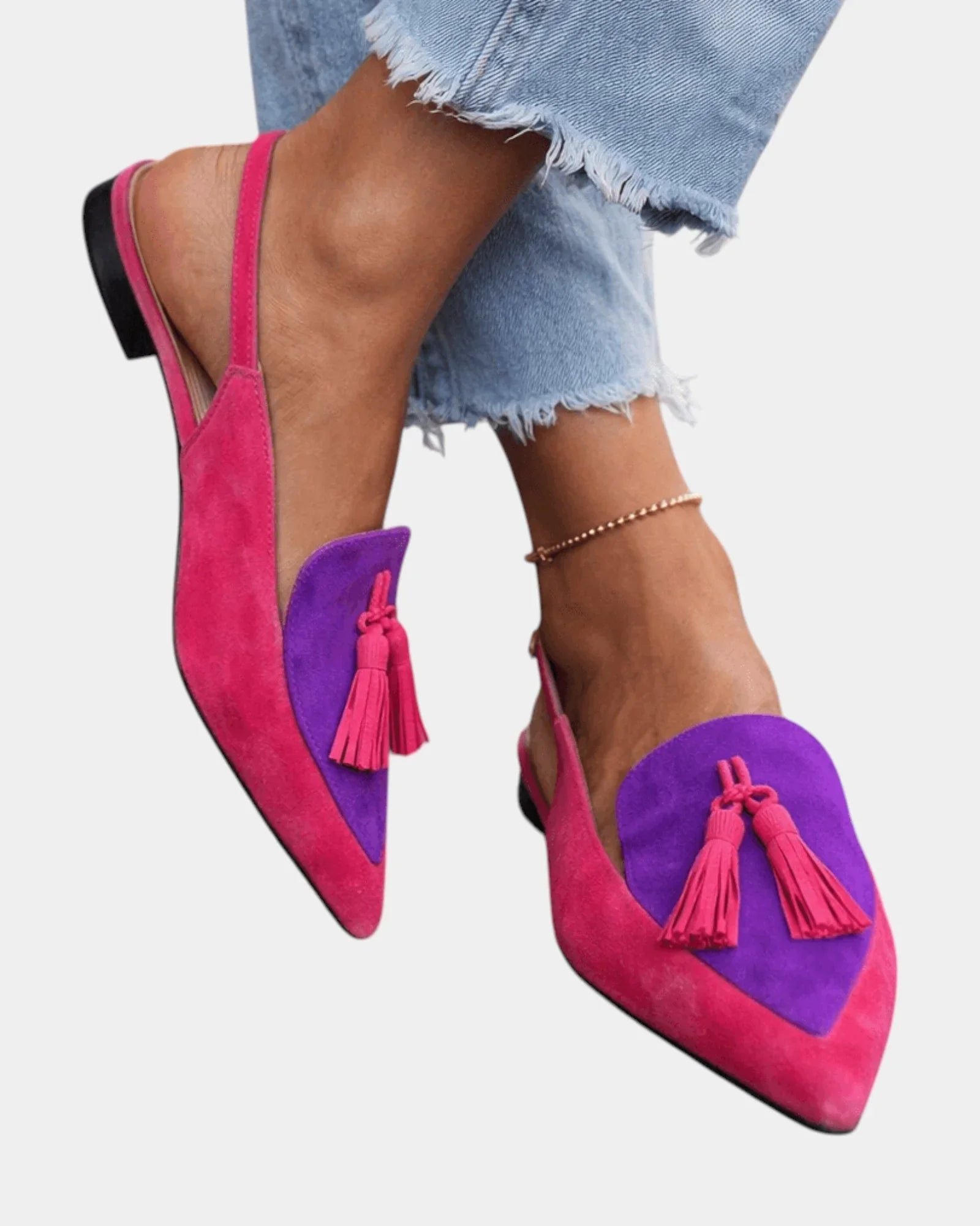 Pink suede heeled sandals with purple panel, tassel fringe, and black heel