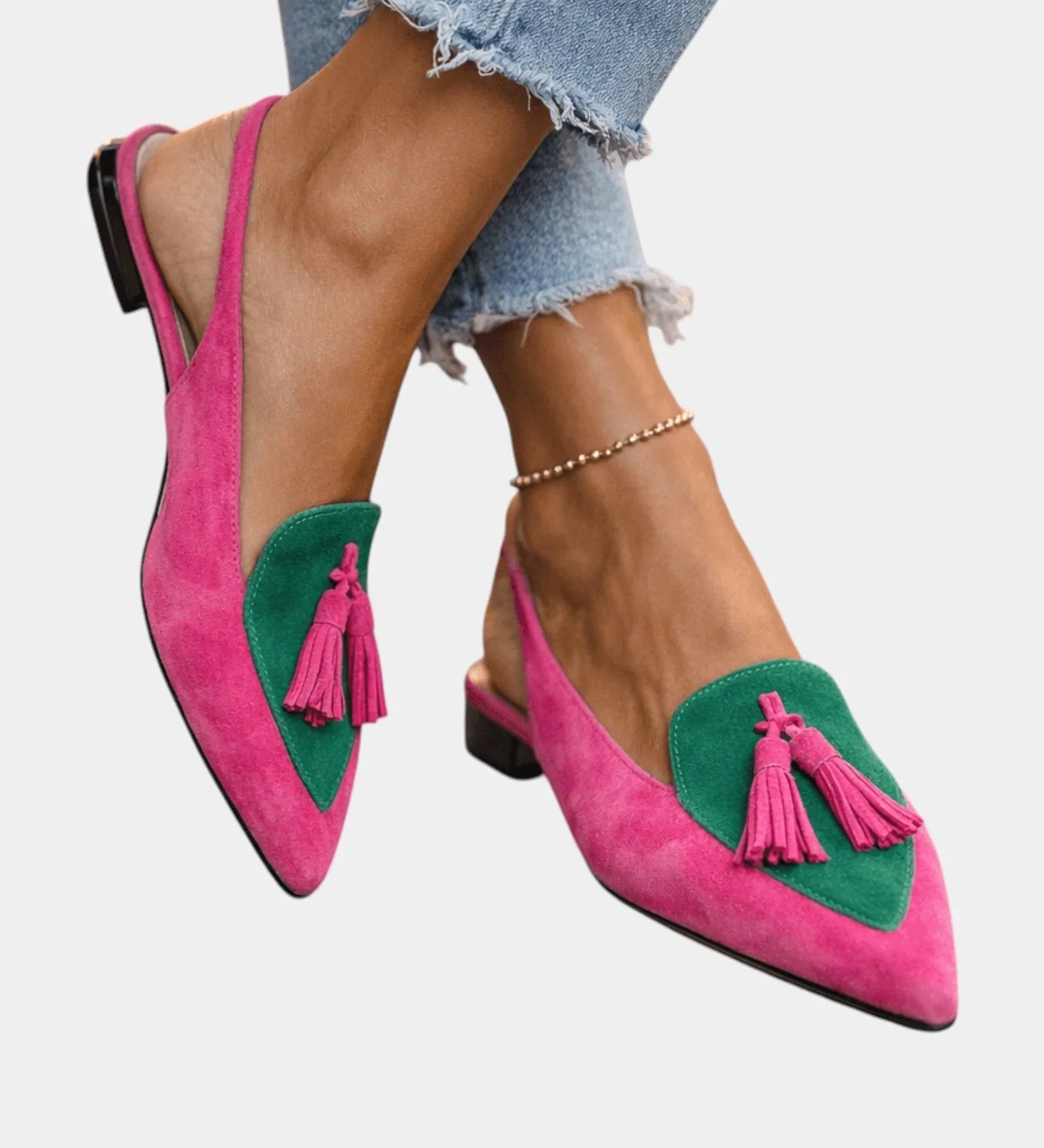 Pink suede heeled sandals with green panel, tassel fringe, and black heel