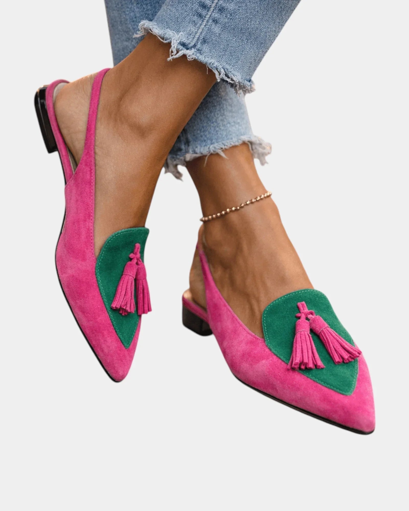 Pink suede heeled sandals with green panel, tassel fringe, and black heel