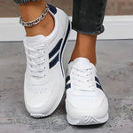 White orthopedic sneakers with navy side stripe and white laces
