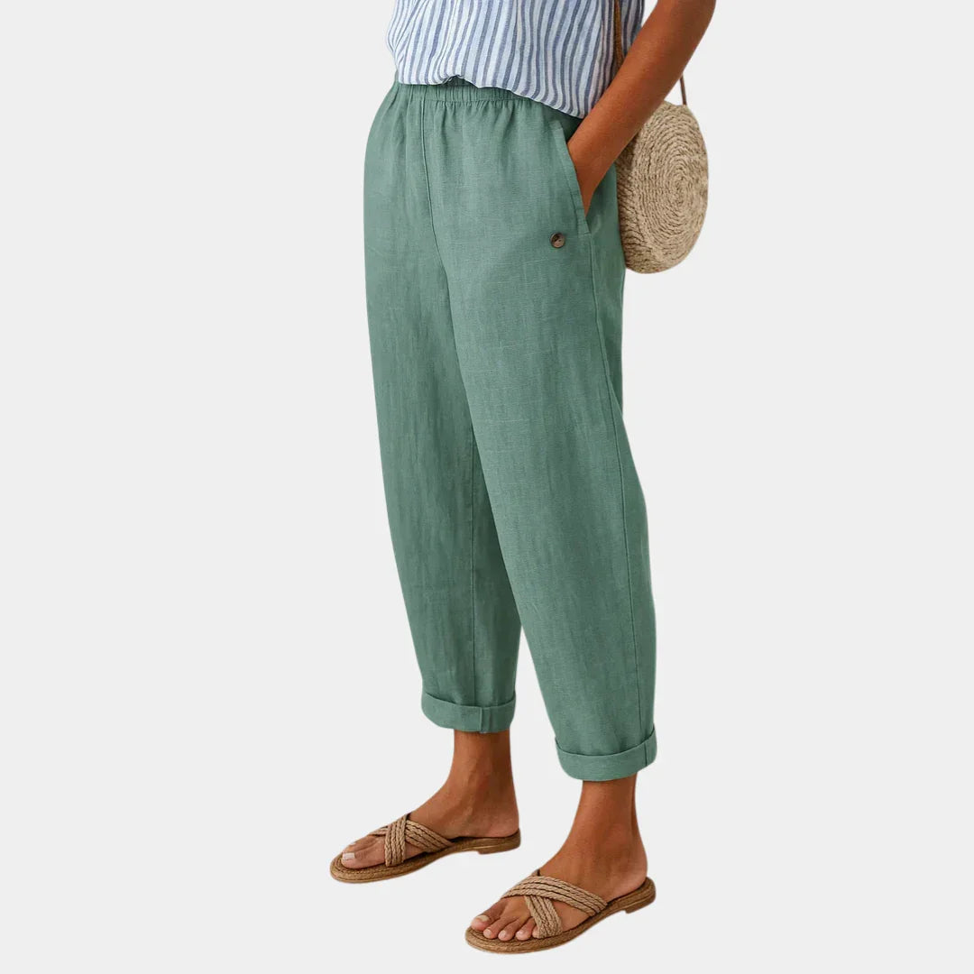 Light green linen-effect pants with elastic waist, button detail, and cuffed ankle hems