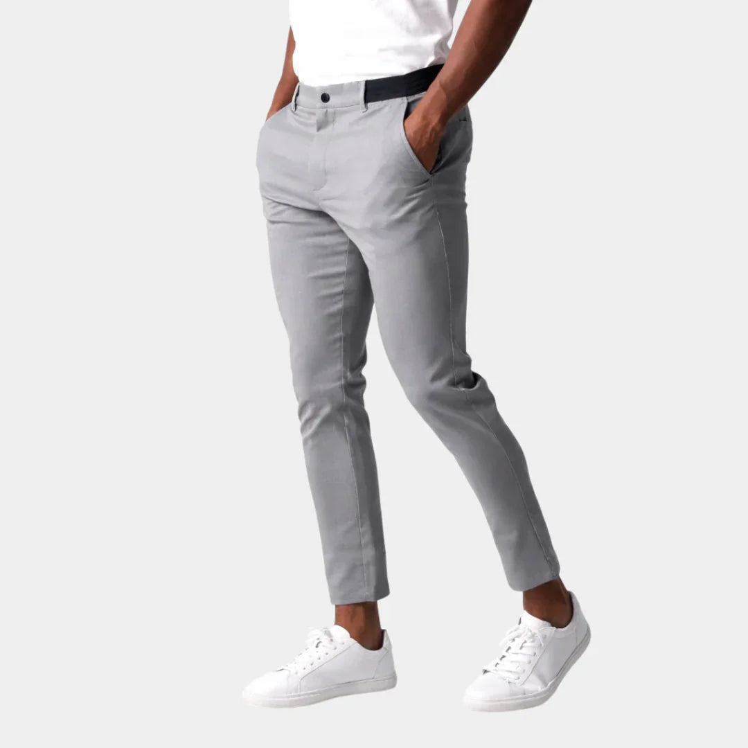 Light gray chino pants with button closure, belt loops, and tapered leg.