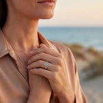 Silver-tone ring with a round engraved sunburst face on a smooth band