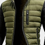 Men's puffer jacket chest close-up: green quilted body, zip pocket and stand collar