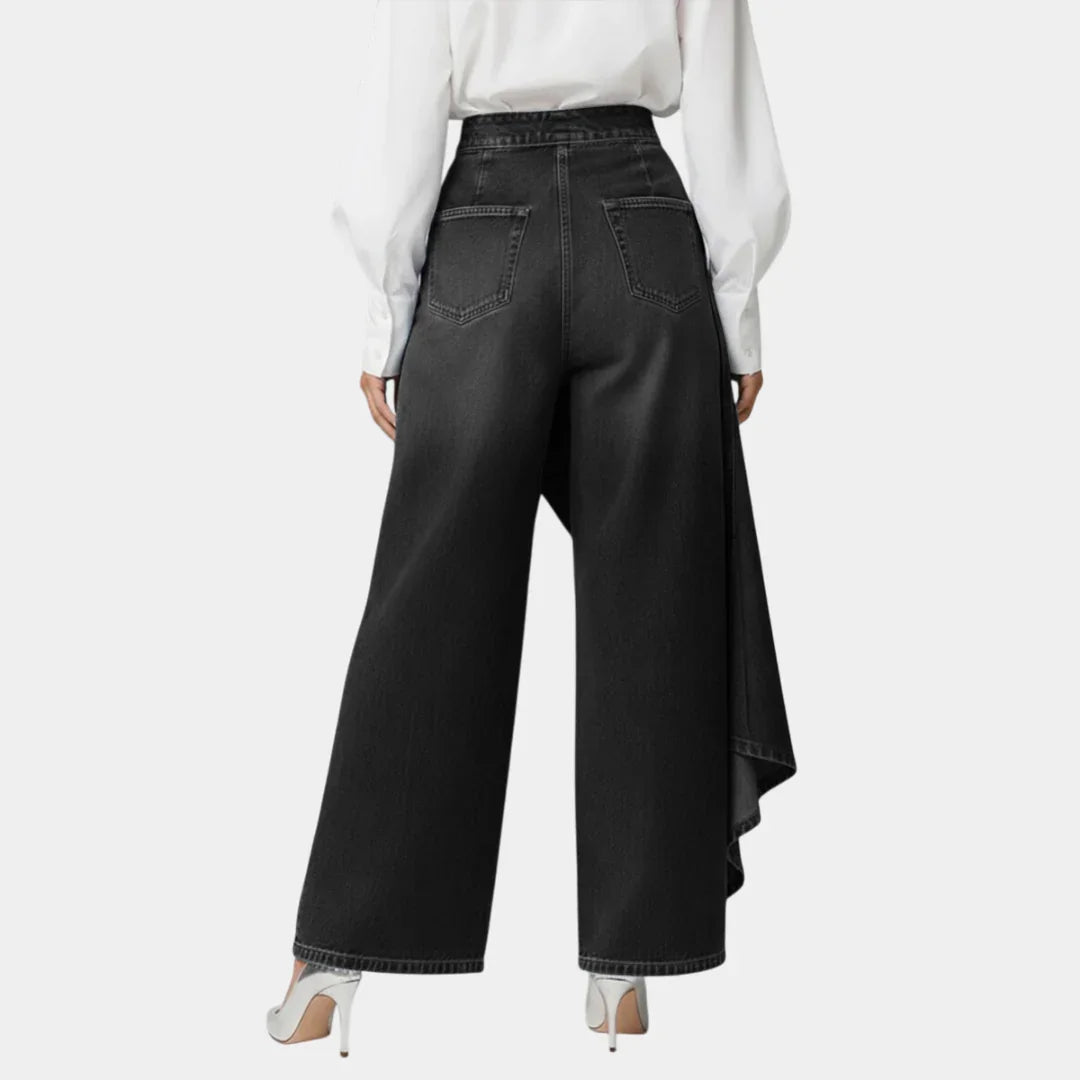 High-waisted wide-leg jeans in black, back view with angled draped side hem