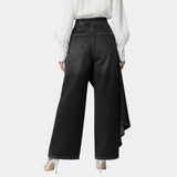 High-waisted wide-leg jeans in black, back view with angled draped side hem