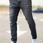 Slim-fit ripped jeans in black wash, distressed knee rips and fitted taper
