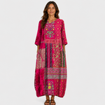 Long magenta printed dress with three-quarter sleeves and patterned border hem