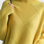 Yellow turtleneck sweater with ribbed collar and diamond quilt-like knit pattern