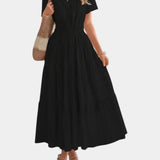 Black tiered maxi dress with V-neck, short sleeves, and elasticated gathered waist
