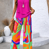 Pink sleeveless tiered top and multicolor abstract wide-leg pants, full outfit