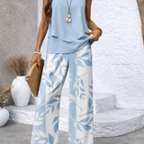 Light blue layered sleeveless top with ruffle hem and wide-leg leaf-print pants