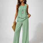Mint green layered sleeveless top with floral print and matching wide-leg pants