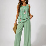 Mint green layered sleeveless top with floral print and matching wide-leg pants