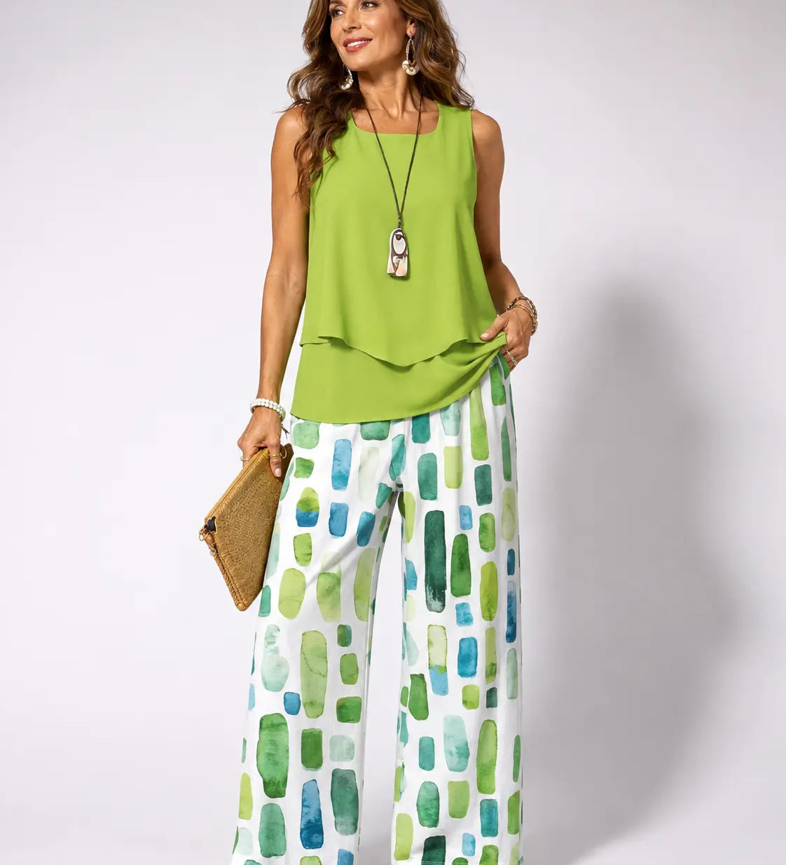 Green sleeveless top with draped hem and green geometric wide-leg pants set