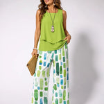 Green sleeveless top with draped hem and green geometric wide-leg pants set