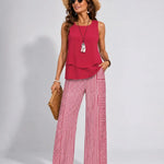 Ramona™ pink sleeveless solid top with ruffled hem and red-striped wide-leg pants