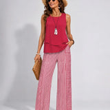 Ramona™ pink sleeveless solid top with ruffled hem and red-striped wide-leg pants