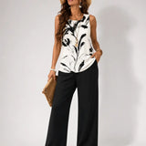 White sleeveless top with black abstract print and black wide-leg pants