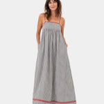 Gray striped summer long dress with spaghetti straps, smocked bodice, and red trim hem