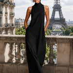 Black sleeveless long minimalist dress with mock neck and flowing skirt
