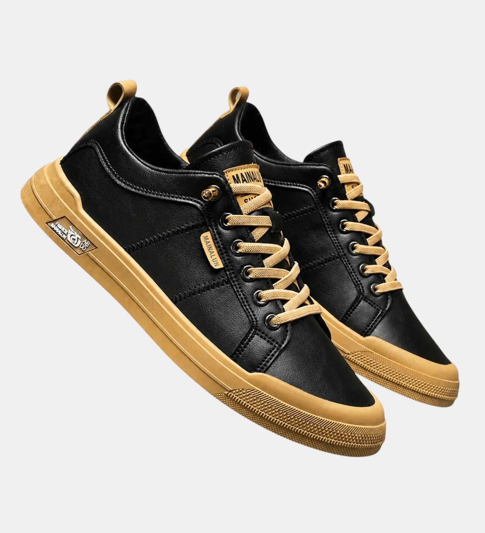 Black classic sneakers with gold trim, tan laces, and chunky gold rubber sole