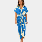 Blue patterned casual dress with short sleeves, button front, and tied waist belt
