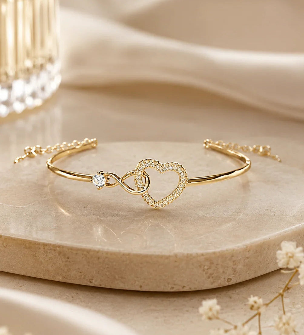 Gold infinity heart bracelet with sparkling crystal heart detail