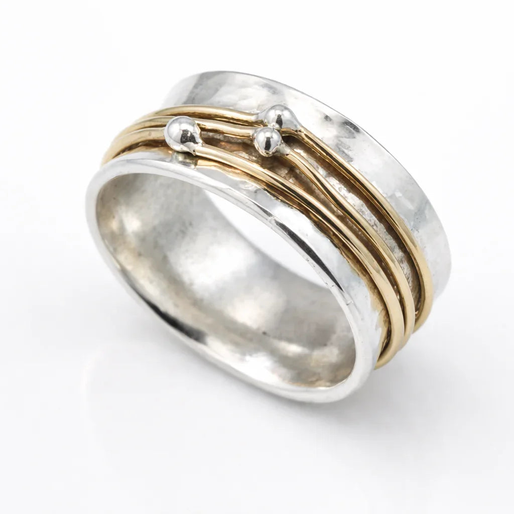 Stacked silver ring with gold-plated band and two rounded details