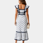 Back view of blue and white striped midi dress with square neckline and ruffled hem
