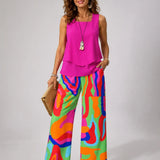 Sleeveless pink layered top with multicolor abstract wide-leg pants