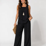 Black layered sleeveless top with wide-leg pants, relaxed two-tier hem