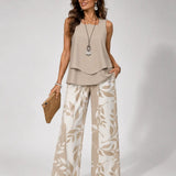 Beige sleeveless tiered top with botanical wide-leg trousers
