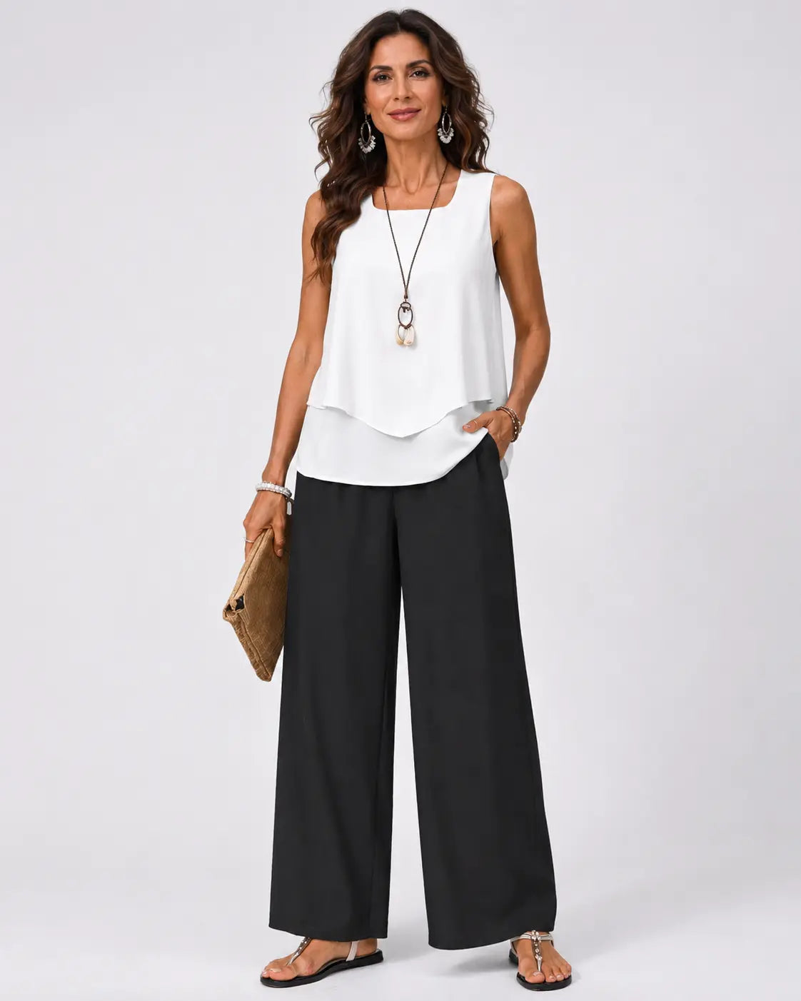 Sleeveless white layered top and black wide-leg pants outfit, full-body view