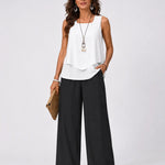 Sleeveless white layered top and black wide-leg pants outfit, full-body view