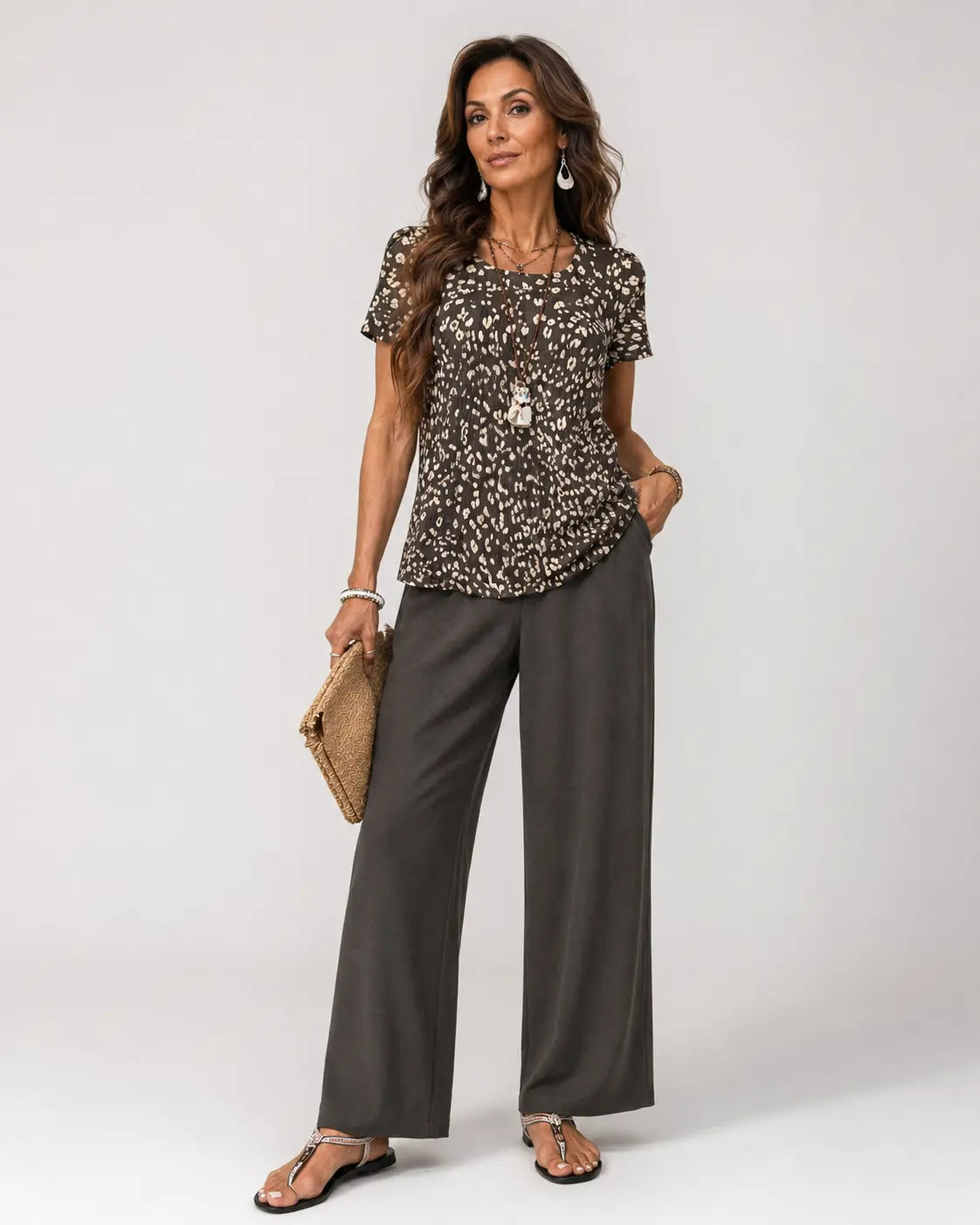 Animal-print short-sleeve top with wide-leg dark gray pants, scoop neckline