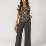 Animal-print short-sleeve top with wide-leg dark gray pants, scoop neckline
