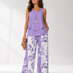 Lilac sleeveless layered blouse with botanical print wide-leg trousers, full length