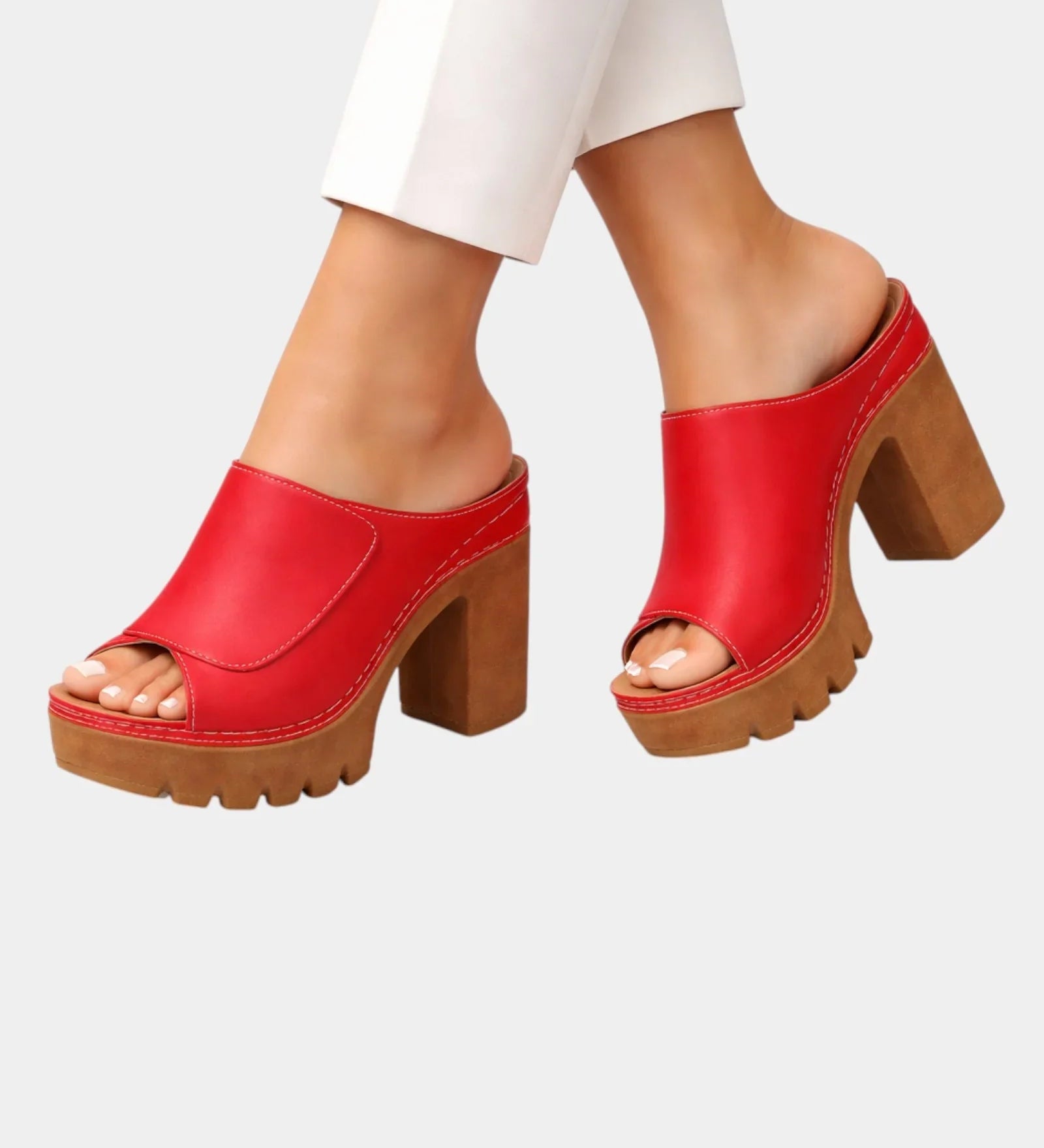 Red platform heeled mules with open toe and chunky lug sole, slip-on upper
