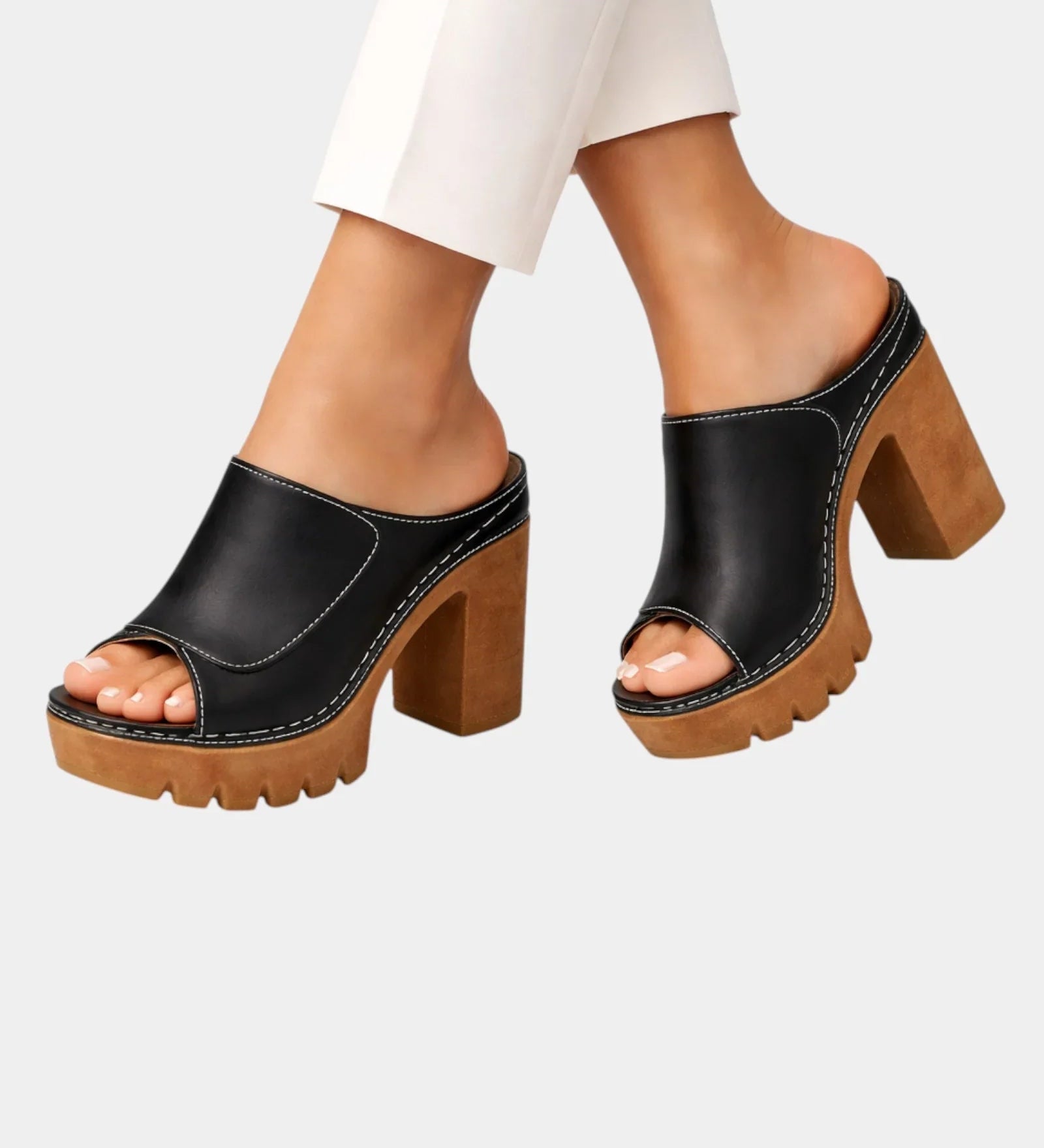 Black and brown platform heeled mules with open toe, slip-on upper, chunky lug sole